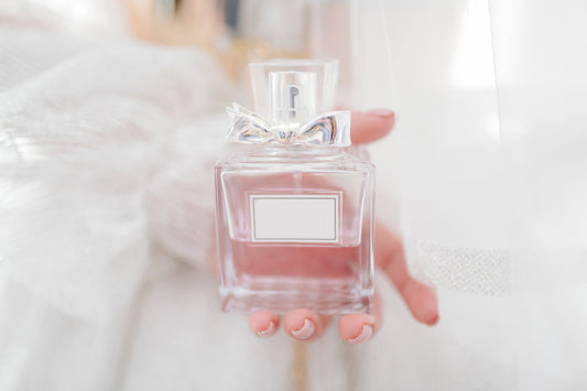 A woman holding a perfume bottle